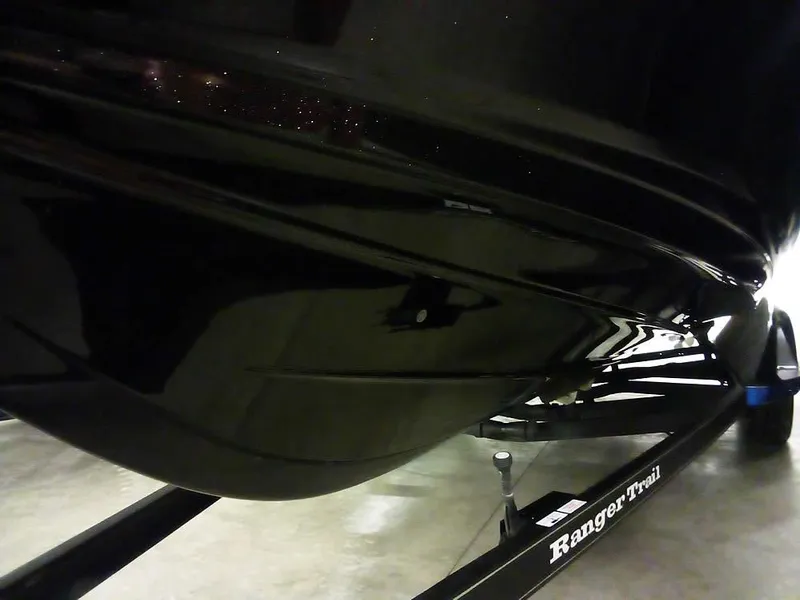 Slide: The Image of 2024 Ranger 622FS Pro DC boat on trailer, sleek black hull design. - 3
