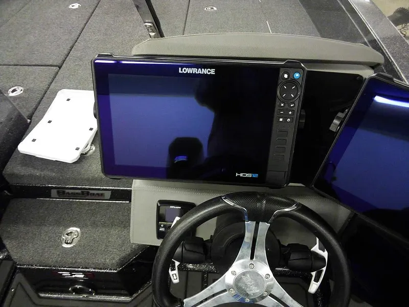 Slide: The Image of 2024 Ranger 622FS Pro DC boat dashboard with Lowrance HDS display and steering wheel. - 30