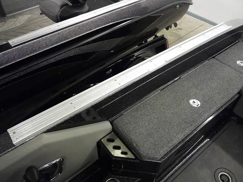 Slide: The Image of 2024 Ranger 622FS Pro DC boat interior with sleek black finish and storage compartment. - 38