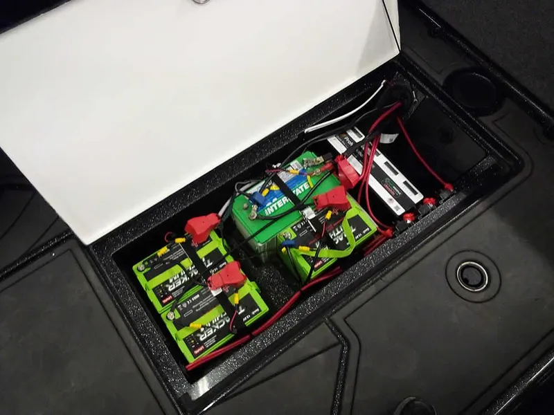 Slide: The Image of Battery compartment of 2024 Ranger 622FS Pro DC boat, featuring multiple green batteries. - 39