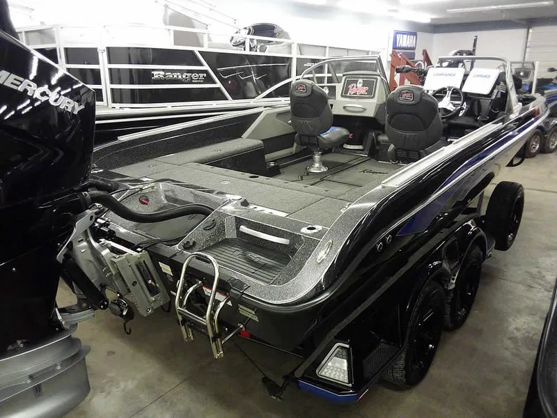 Slide: The Image of 2024 Ranger 622FS Pro DC boat in showroom, featuring dual seats and Mercury engine. - 5