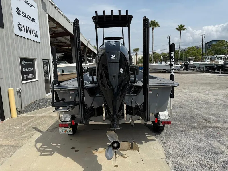 Slide: The Image of 2024 Blazer 2400 boat with outboard motor, parked at a dealership with Suzuki and Yamaha signage. - 10