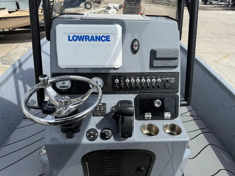 Slide: The Image of 2024 Blazer 2400 boat dashboard with Lowrance system and steering wheel. - 14