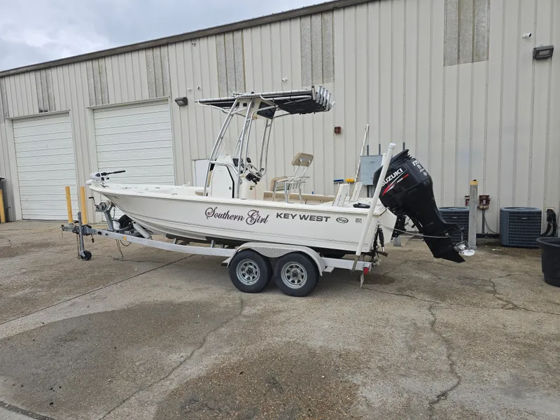 Slide: The Image of 2014 Key West 210 Bay Reef boat on trailer, parked outside a warehouse. - 3