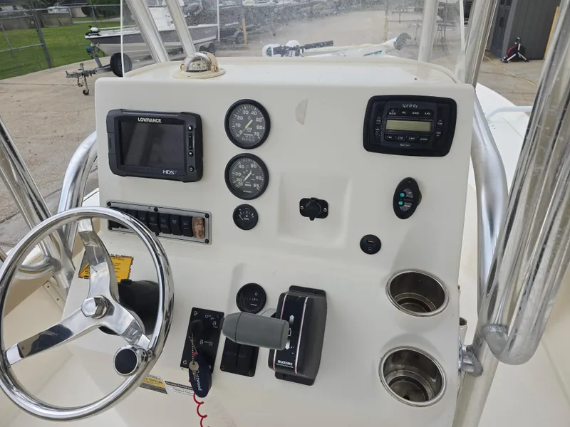 Slide: The Image of 2014 Key West 210 Bay Reef boat console with steering wheel and navigation instruments. - 9