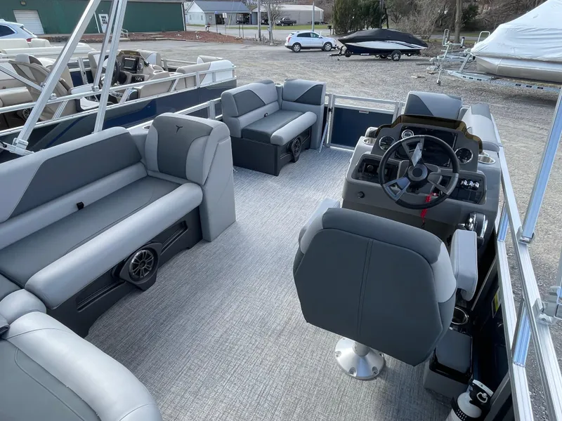 Slide: The Image of 2025 Tahoe Pontoon 1980 Sport Cruise interior with gray seating and steering console. - 14