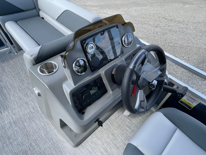 Slide: The Image of 2025 Tahoe Pontoon 1980 Sport Cruise dashboard with steering wheel and controls. - 17