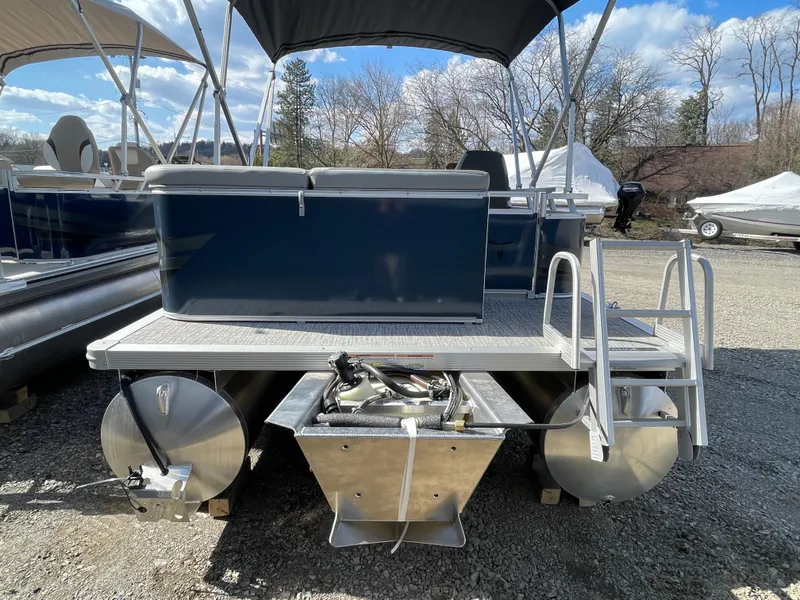 Slide: The Image of 2025 Tahoe Pontoon 1980 Sport Cruise, rear view, parked outdoors under blue sky. - 5