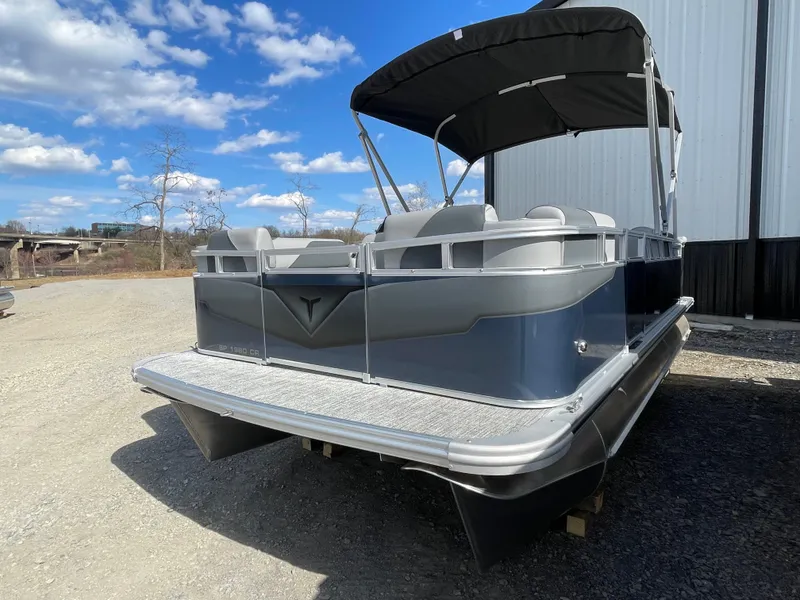 Slide: The Image of 2025 Tahoe Pontoon 1980 Sport Cruise boat with canopy, parked outdoors under blue sky. - 7