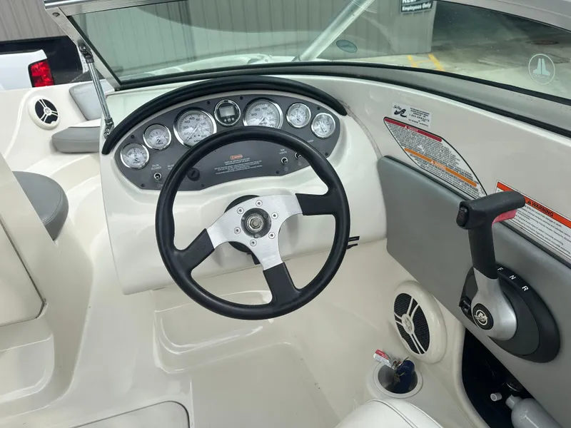 Slide: The Image of 2008 Sea Ray 185 Sport boat dashboard with steering wheel and control panel. - 2