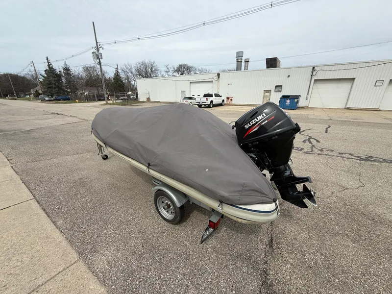Slide: The Image of 2016 Highfield Classic 360 FCT boat on trailer, covered, with Suzuki outboard motor. - 10
