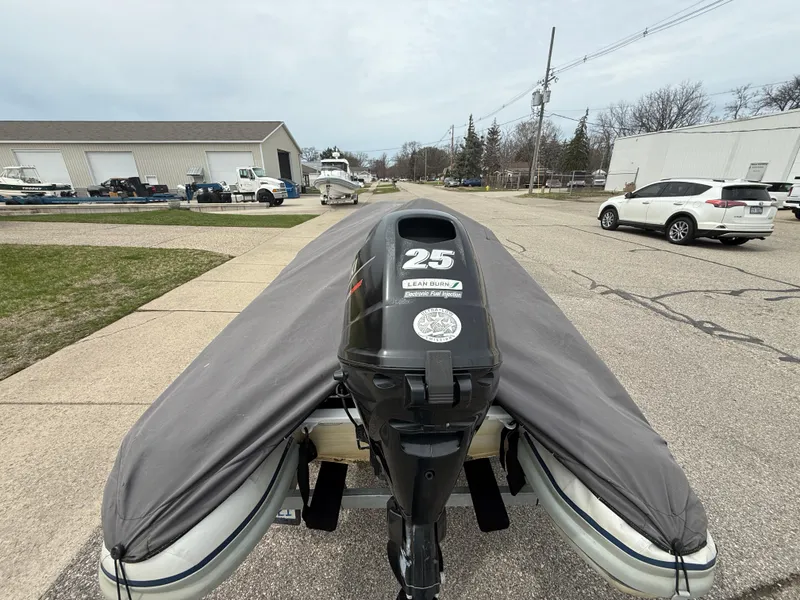 Slide: The Image of 2016 Highfield Classic 360 FCT boat with a 25 HP engine, covered and parked outdoors. - 11