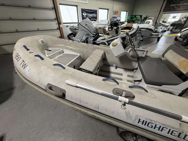 Slide: The Image of 2016 Highfield Classic 360 FCT inflatable boat in showroom, featuring steering console and seating. - 3
