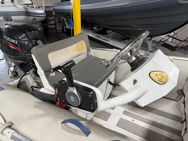 Slide: The Image of 2016 Highfield Classic 360 FCT boat with Suzuki outboard motor in a showroom. - 5