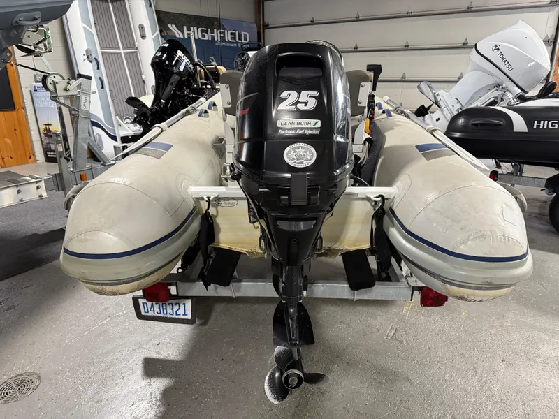 Slide: The Image of 2016 Highfield Classic 360 FCT inflatable boat with 25 HP outboard motor in a garage. - 6