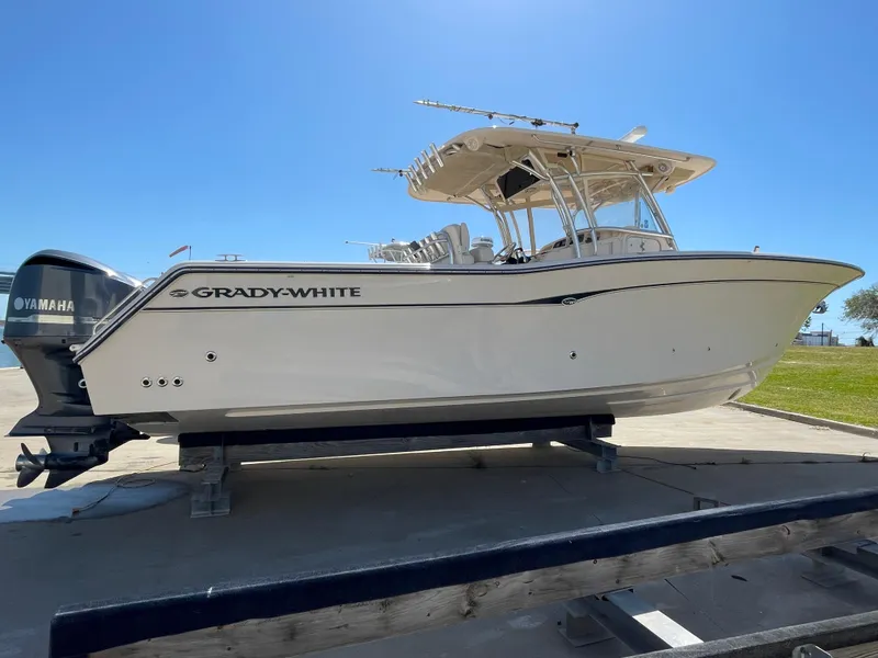 Slide: The Image of 2008 Grady-White Canyon 336 boat on trailer, side view, clear sky background. - 0