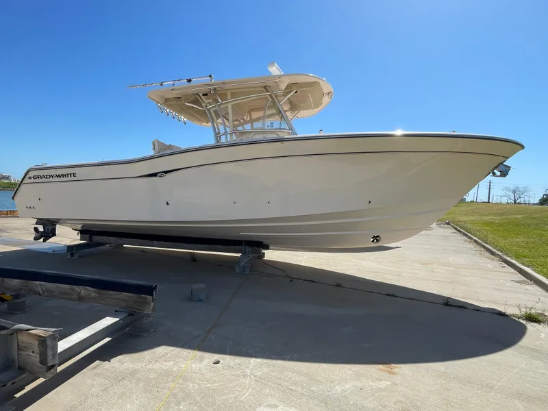 Slide: The Image of 2008 Grady-White Canyon 336 boat on trailer under clear blue sky. - 1
