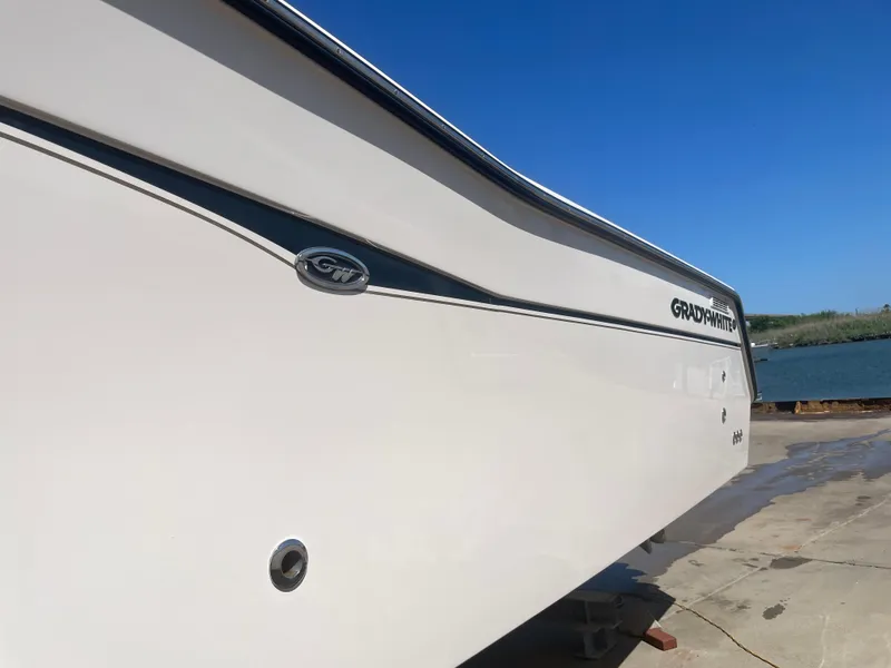 Slide: The Image of 2008 Grady-White Canyon 336 boat side view, docked near water. - 15