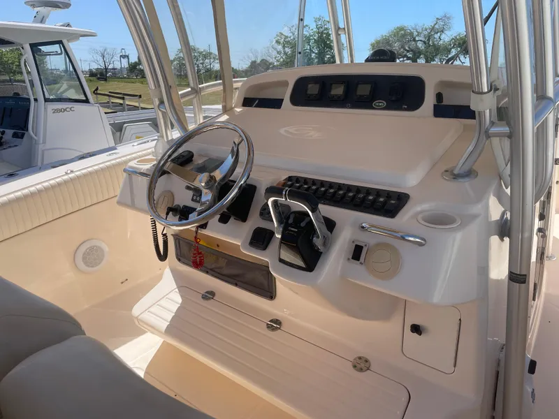 Slide: The Image of 2008 Grady-White Canyon 336 boat helm with steering wheel and controls. - 18