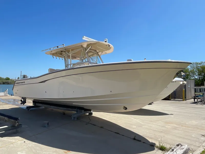 Slide: The Image of 2008 Grady-White Canyon 336 boat on trailer under clear blue sky. - 2