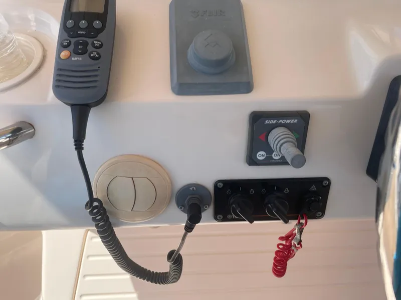 Slide: The Image of Control panel of a 2008 Grady-White Canyon 336 boat with radio and switches. - 20