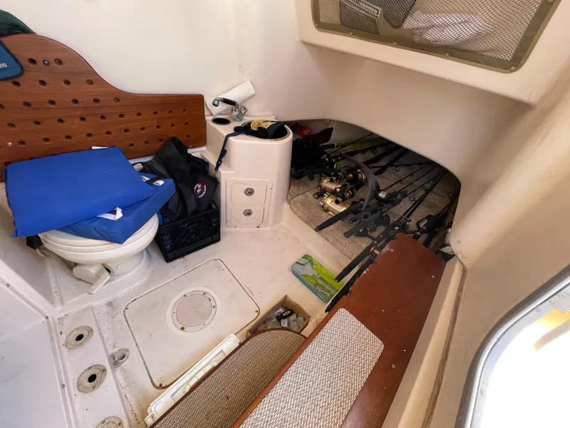 Slide: The Image of 2008 Grady-White Canyon 336 cabin interior with fishing gear and storage. - 25