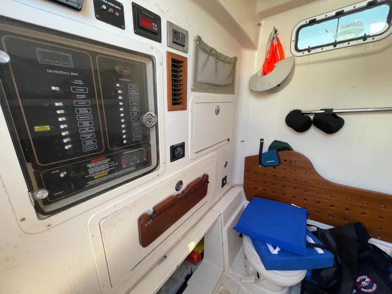 Slide: The Image of 2008 Grady-White Canyon 336 cabin interior with control panel and storage. - 26