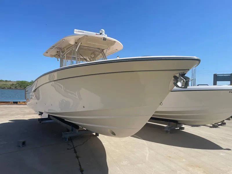 Slide: The Image of 2008 Grady-White Canyon 336 boat on a sunny day, docked on a concrete surface. - 3