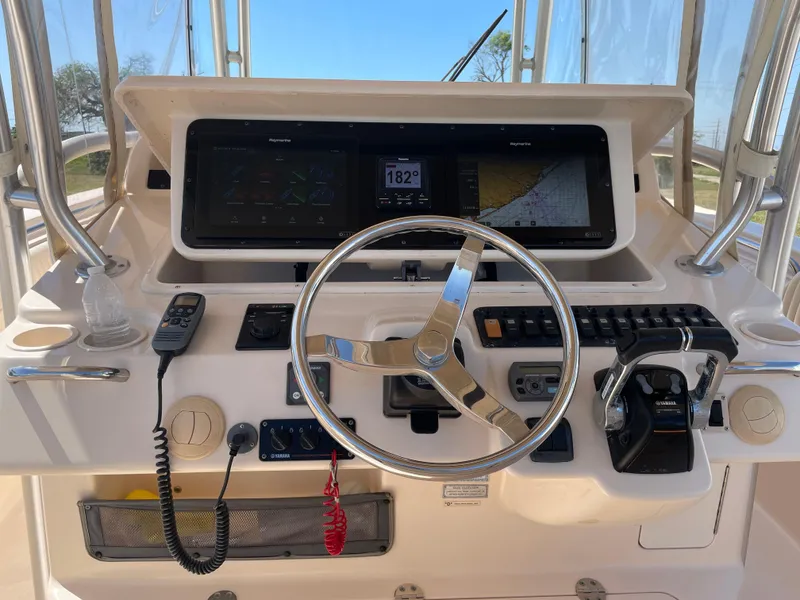 Slide: The Image of Control panel of a 2008 Grady-White Canyon 336 boat with steering wheel and navigation equipment. - 31
