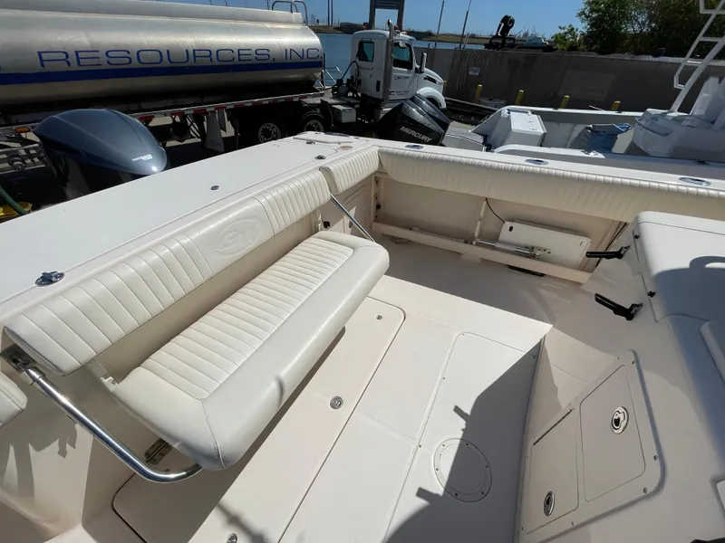 Slide: The Image of 2008 Grady-White Canyon 336 boat interior with white seating and storage compartments. - 36