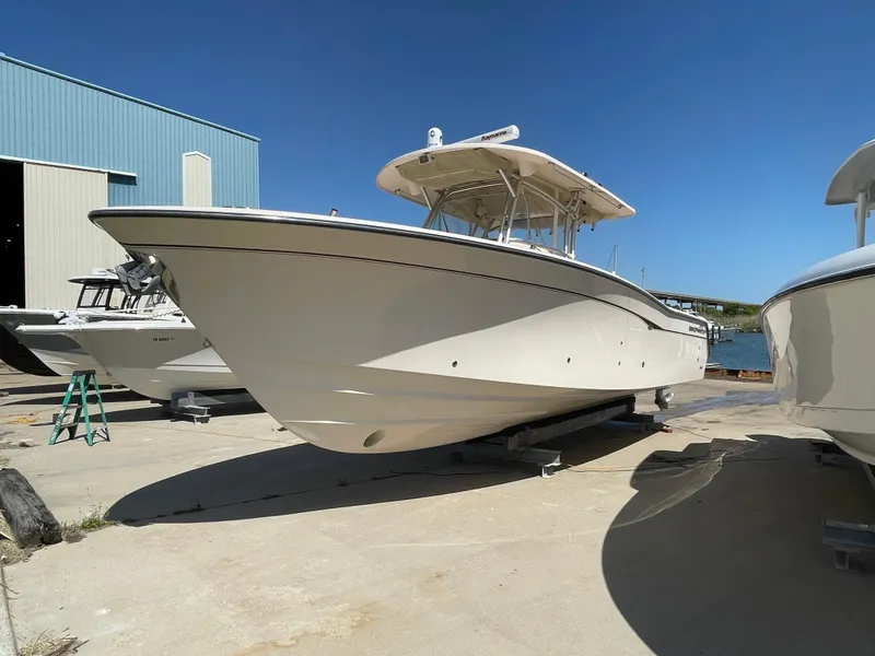 Slide: The Image of 2008 Grady-White Canyon 336 boat on dry dock under clear blue sky. - 4
