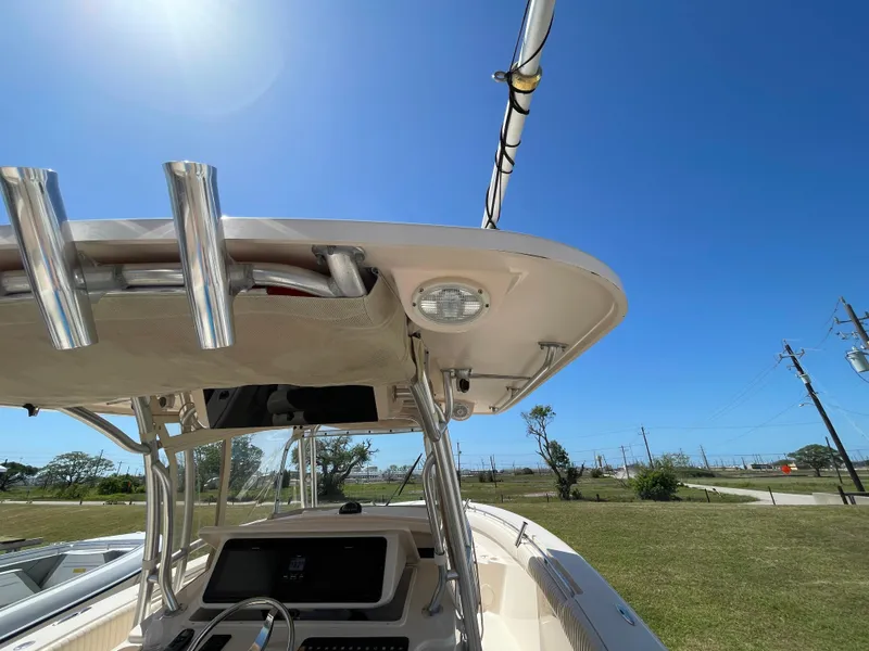 Slide: The Image of 2008 Grady-White Canyon 336 boat under clear blue sky, showcasing helm and T-top. - 41
