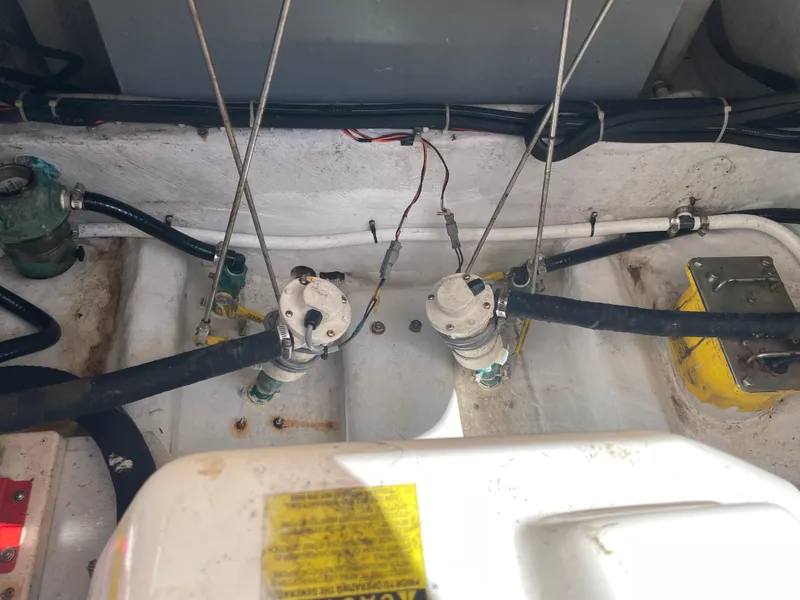 Slide: The Image of Engine compartment of a 2008 Grady-White Canyon 336 boat, showing hoses and components. - 45