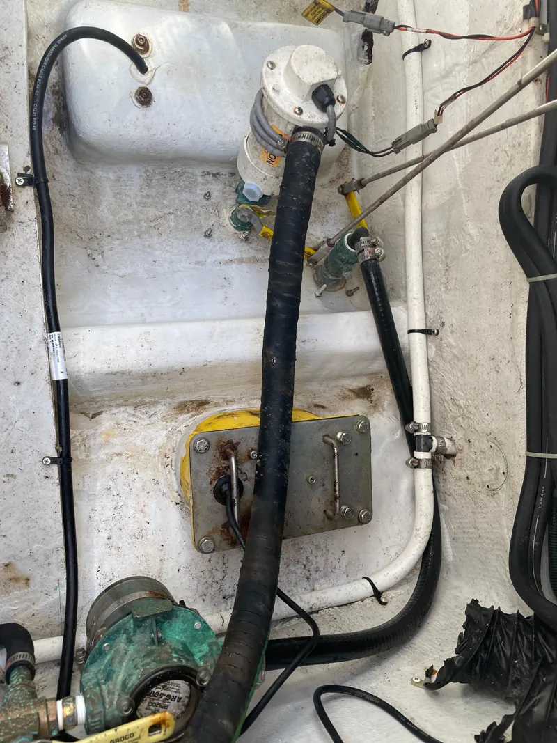 Slide: The Image of Engine compartment of a 2008 Grady-White Canyon 336 boat, showing hoses and mechanical components. - 47