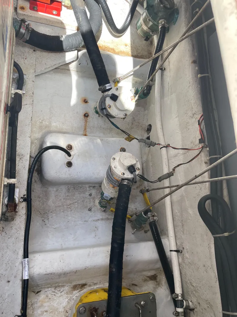 Slide: The Image of 2008 Grady-White Canyon 336 boat engine compartment with hoses and mechanical components. - 48