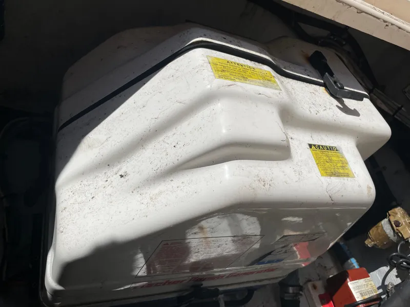 Slide: The Image of 2008 Grady-White Canyon 336 boat engine compartment with white fuel tank. - 49