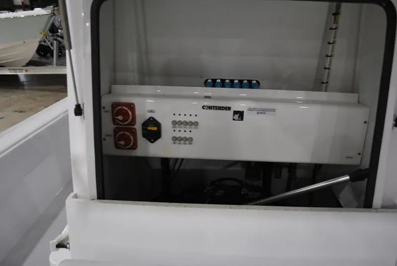 Slide: The Image of 2025 Contender 25 Bay boat electrical panel with switches and controls. - 15