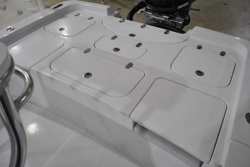 Slide: The Image of 2025 Contender 25 Bay boat deck with multiple storage compartments. - 17