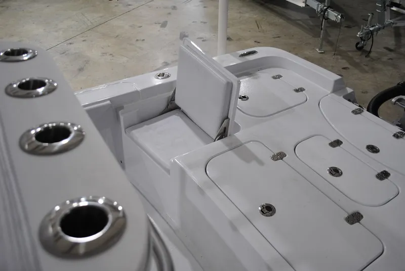 Slide: The Image of 2025 Contender 25 Bay boat interior with storage compartments and rod holders. - 19