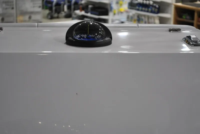Slide: The Image of 2025 Contender 25 Bay boat compass on white dashboard. - 21