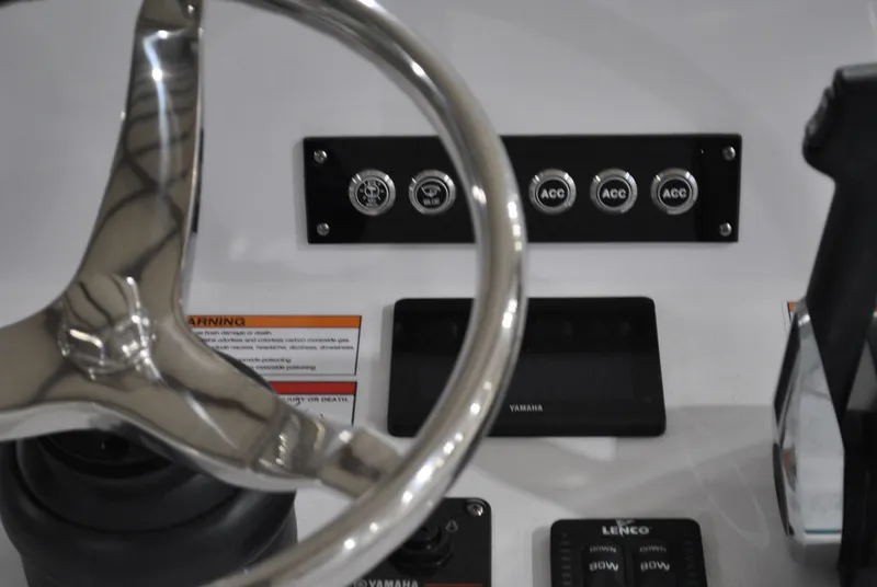 Slide: The Image of Steering wheel and control panel of 2025 Contender 25 Bay boat. - 23