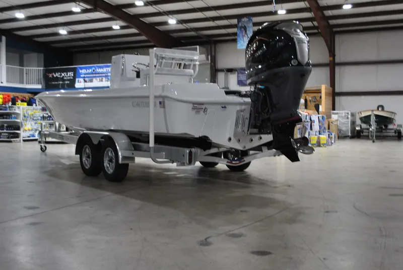 Slide: The Image of 2025 Contender 25 Bay boat on trailer in spacious indoor showroom. - 4