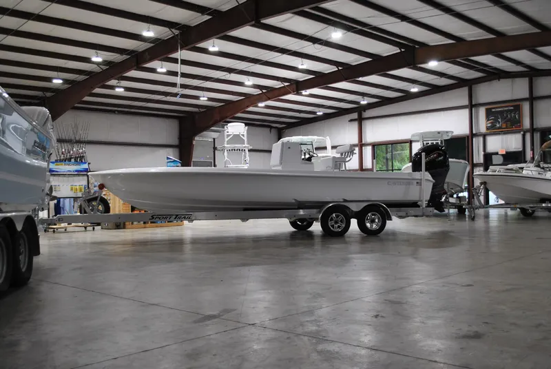 Slide: The Image of 2025 Contender 25 Bay boat on trailer in spacious indoor facility. - 5
