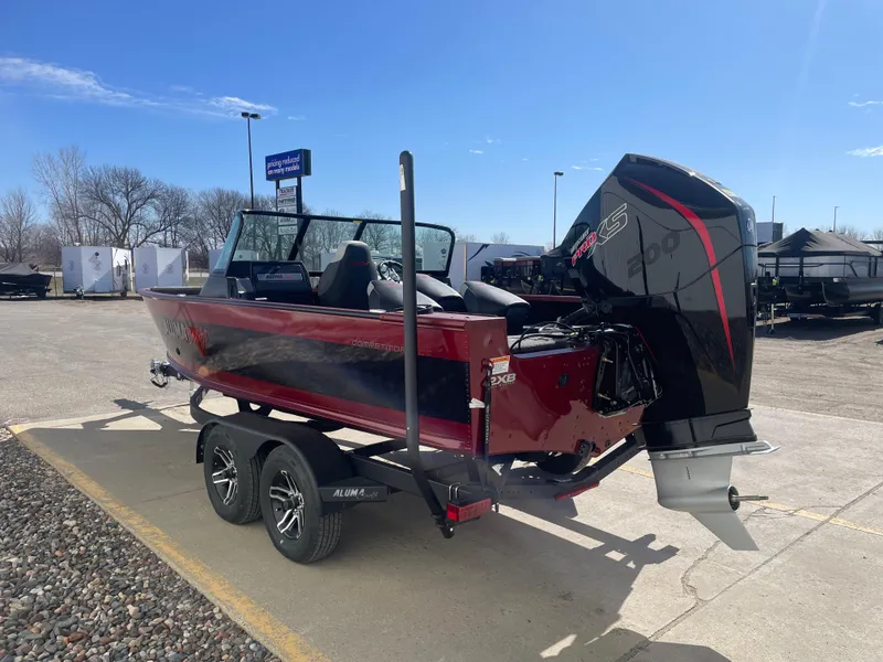 Slide: The Image of 2024 Alumacraft Competitor 205 Sport boat on trailer, parked outdoors under clear sky. - 8