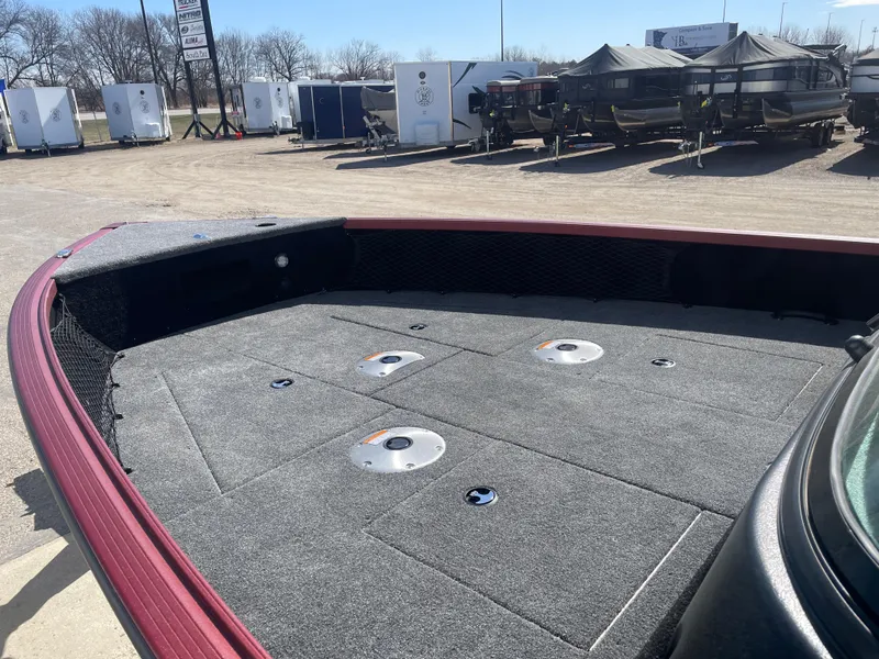 Slide: The Image of 2024 Alumacraft Competitor 205 Sport boat deck, spacious and carpeted, in a sunny outdoor setting. - 9