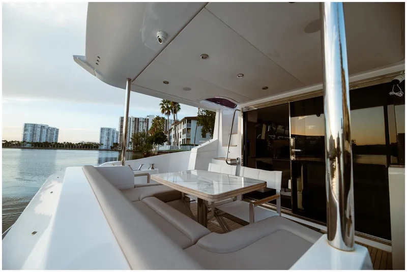 Slide: The Image of Luxurious Azimut 2022 Fly yacht deck with seating, table, and waterfront view. - 10