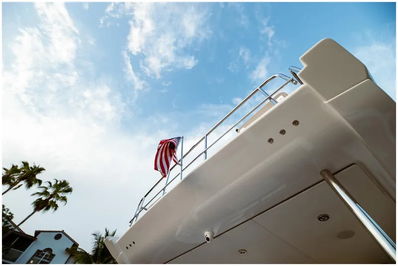 Slide: The Image of Azimut 2022 Fly yacht with American flag against blue sky background. - 12