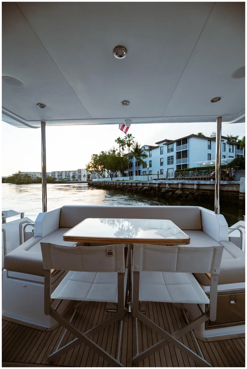 Slide: The Image of Luxury Azimut 2022 Fly yacht deck with elegant seating and waterfront view. - 13