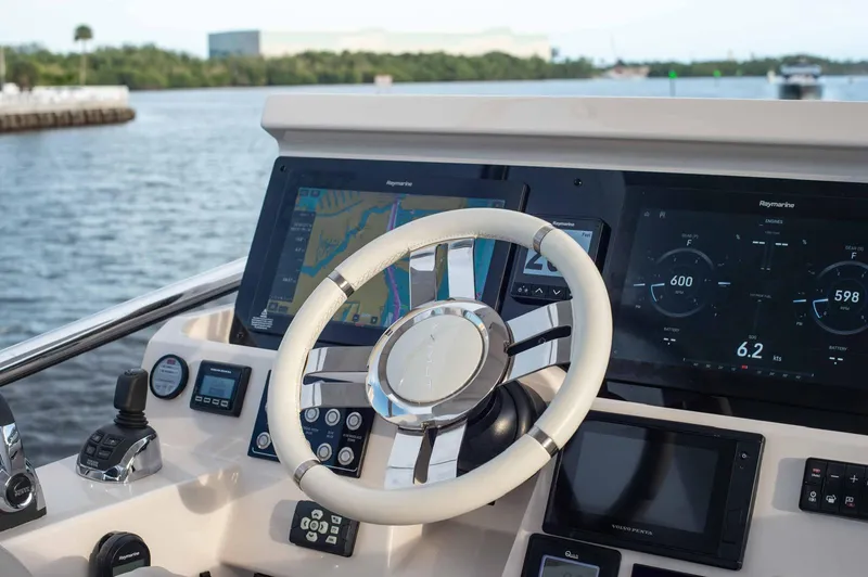 Slide: The Image of Cockpit of 2022 Azimut 50 Fly yacht with modern navigation displays and steering wheel. - 17