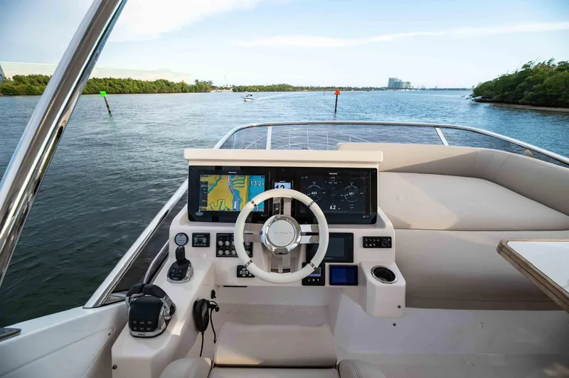 Slide: The Image of Cockpit view of 2022 Azimut 50 Fly yacht with navigation screens and steering wheel. - 18